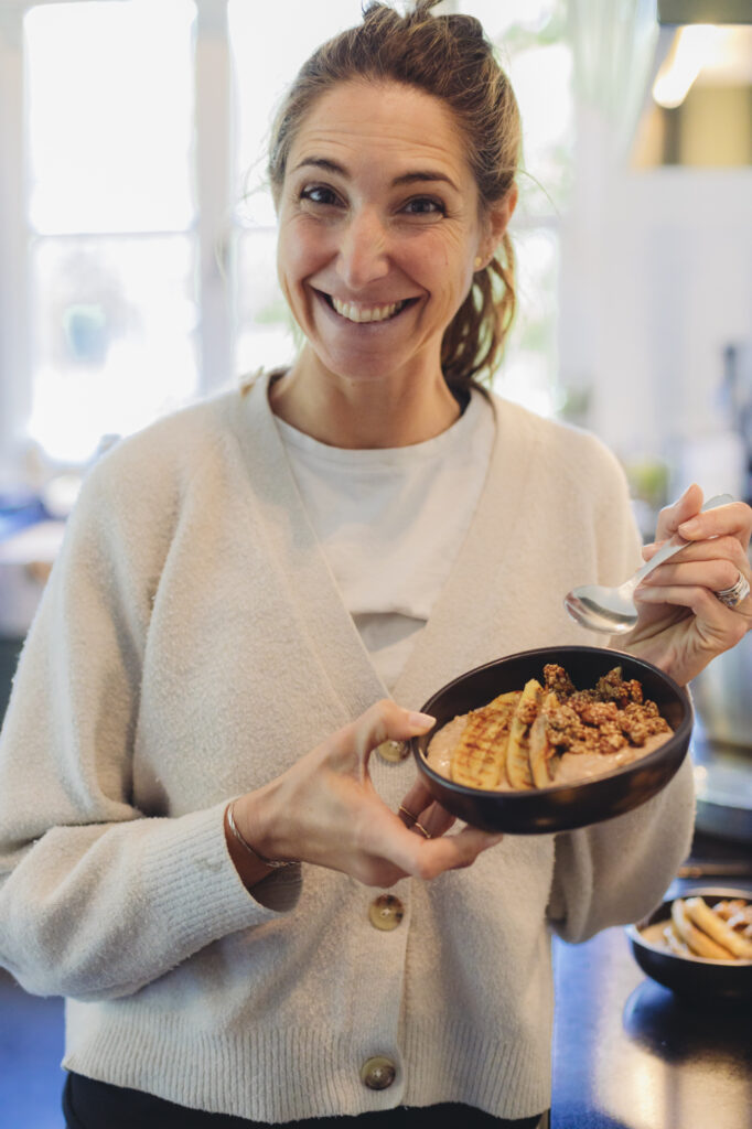 A Smiling Women Enjoying Her Food At Women's Retreat In Zeeland
